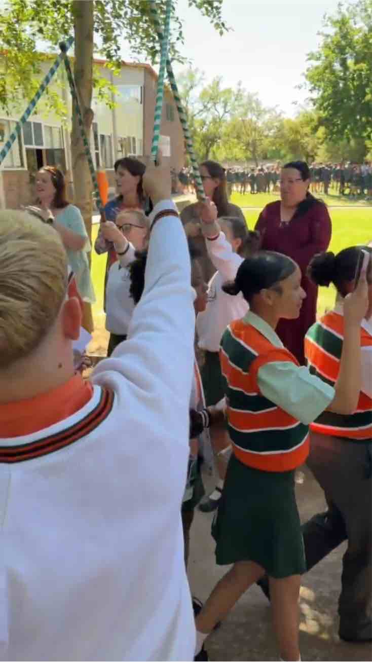 Learners and teachers form a guard of honour for the Matrics